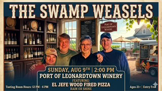 Group of four people at Port of Leonardtown Winery with tasting room background.